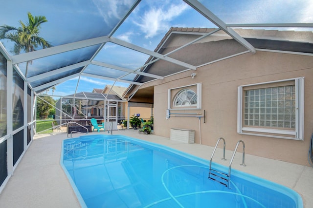 12693 Coral Breeze Dr, Wellington, FL 33414 - outdoor pool featuring glass enclosure and a patio area