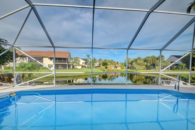 12693 Coral Breeze Dr, Wellington, FL 33414 - view of swimming pool featuring glass enclosure, a water view, and a patio area