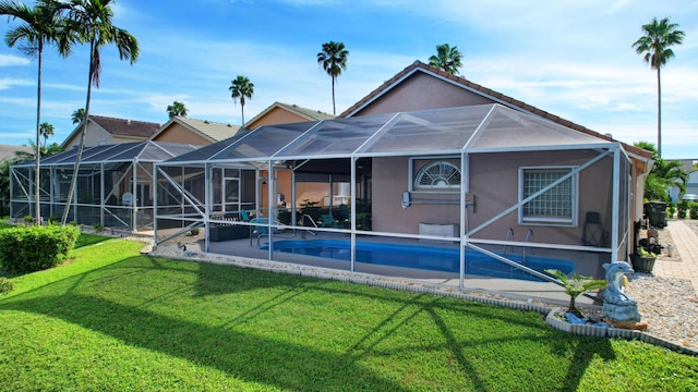 12693 Coral Breeze Dr, Wellington, FL 33414 - back of house featuring a tile roof, a yard, a patio area, and stucco siding