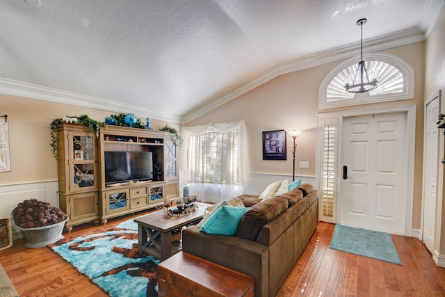 12693 Coral Breeze Dr, Wellington, FL 33414 - living area with wood-type flooring, a chandelier, wainscoting, and vaulted ceiling