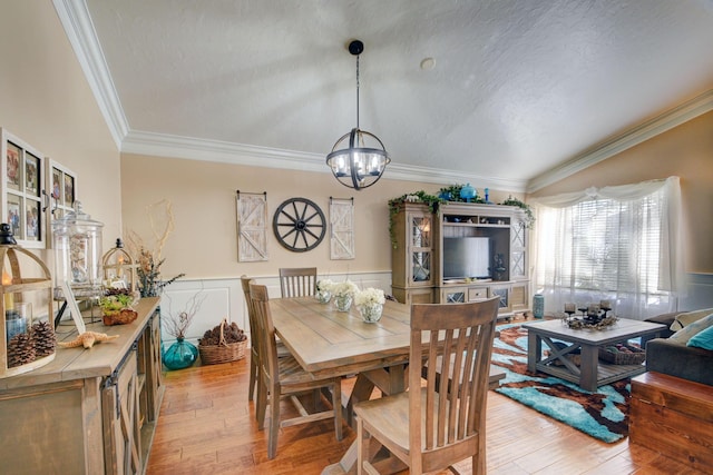 12693 Coral Breeze Dr, Wellington, FL 33414 - dining room featuring a notable chandelier, wainscoting, crown molding, and light wood finished floors