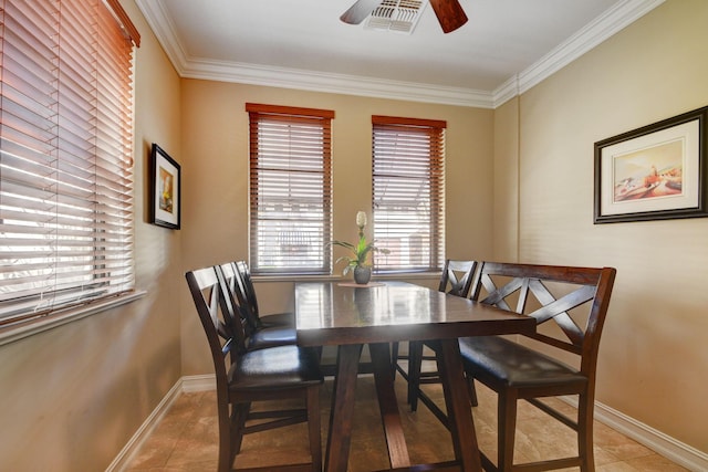 dining area with visible vents, crown molding, baseboards, ceiling fan, and light tile patterned floors