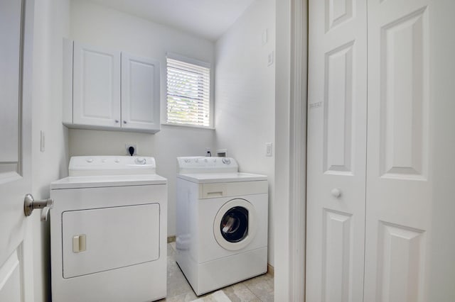 laundry area featuring washer and dryer and cabinet space