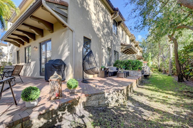 view of patio with area for grilling and stairway