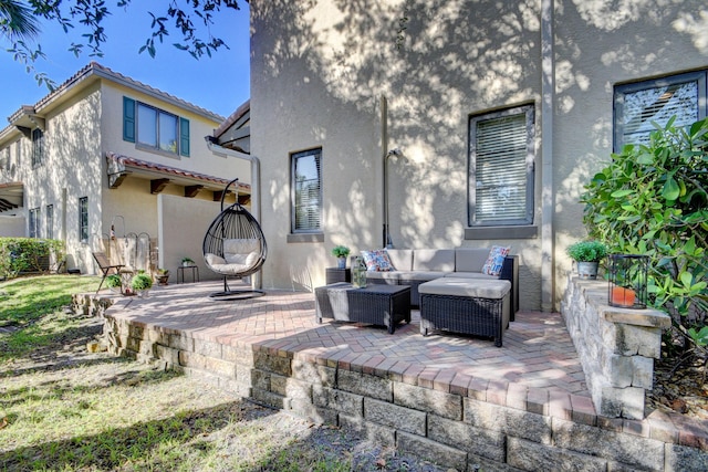 back of property with a patio area, an outdoor living space, stucco siding, and a tile roof