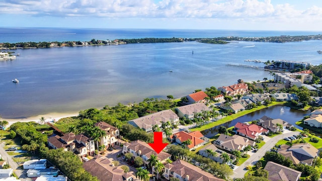 drone / aerial view with a residential view and a water view