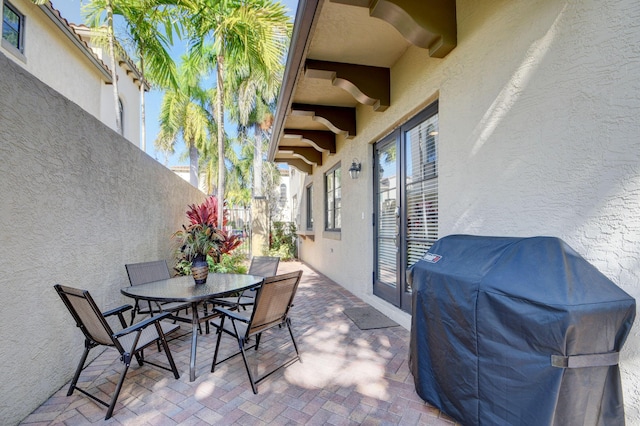 view of patio with outdoor dining area and grilling area