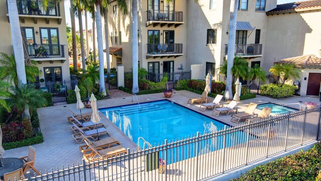 community pool featuring a patio and fence
