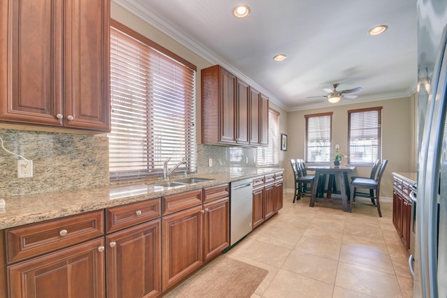 kitchen featuring light tile patterned floors, a ceiling fan, a sink, dishwasher, and crown molding