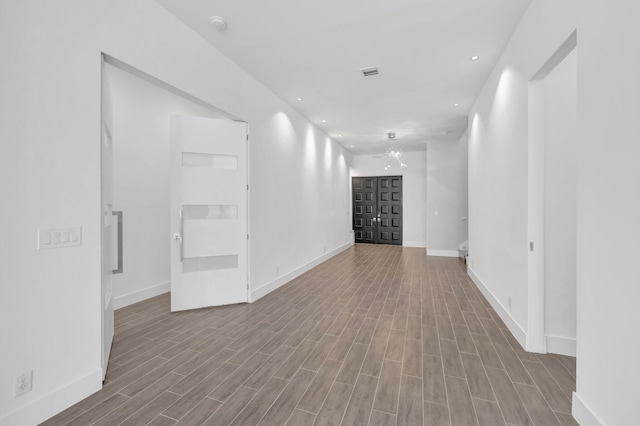 hallway with recessed lighting, baseboards, and wood finished floors