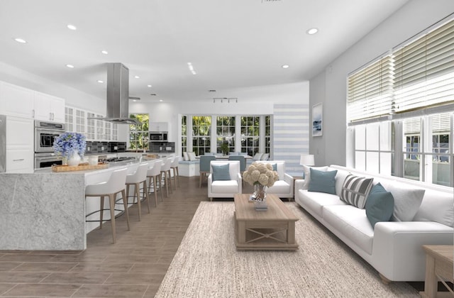 living area with wood finished floors and recessed lighting