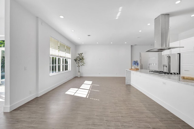 unfurnished living room featuring recessed lighting, light wood-style flooring, baseboards, and visible vents