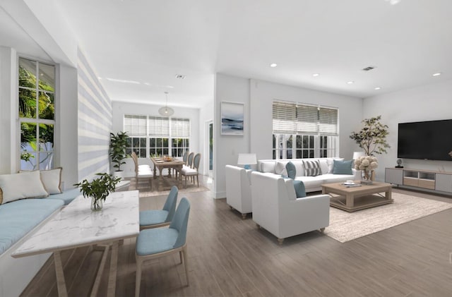 living area featuring wood finished floors, visible vents, plenty of natural light, and recessed lighting