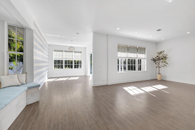 unfurnished living room with visible vents, baseboards, recessed lighting, and wood finished floors