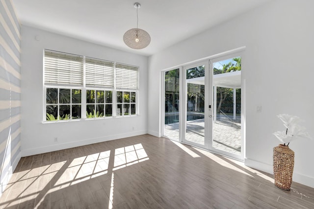 interior space featuring baseboards and wood finished floors