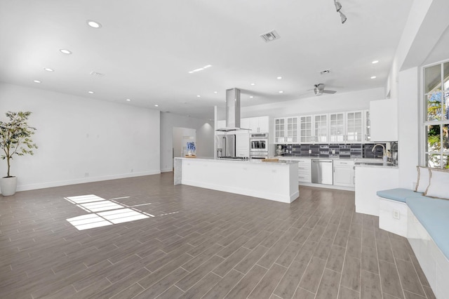 kitchen with visible vents, recessed lighting, island exhaust hood, a sink, and stainless steel appliances