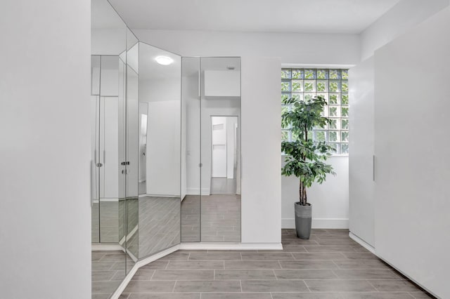 bathroom with baseboards and wood finish floors