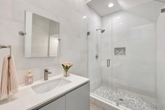 bathroom featuring a shower stall, recessed lighting, and vanity