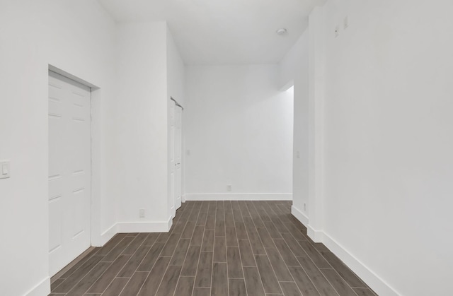 unfurnished room featuring baseboards and wood finished floors