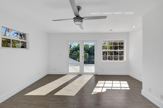 spare room with ceiling fan, french doors, baseboards, and wood finished floors
