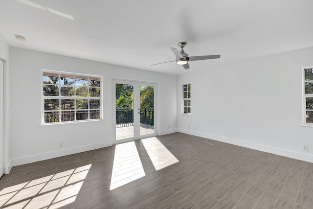 empty room with french doors, baseboards, a ceiling fan, and wood finished floors