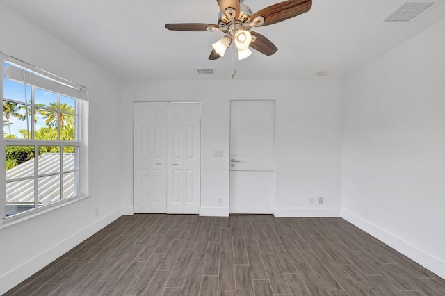 unfurnished bedroom with visible vents, baseboards, and wood finished floors