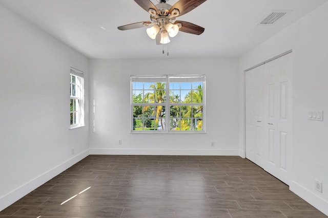unfurnished bedroom with visible vents, baseboards, and multiple windows