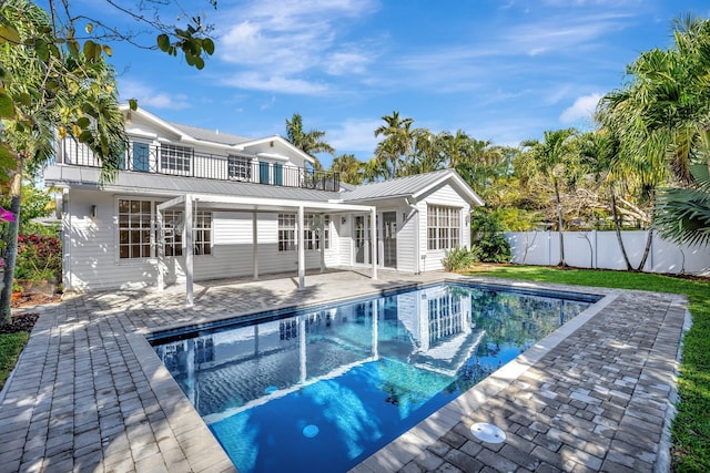 view of swimming pool with a patio area, fence, and a fenced in pool