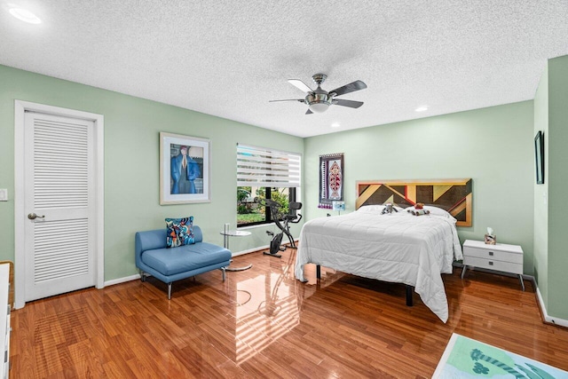 bedroom featuring baseboards, ceiling fan, and wood finished floors