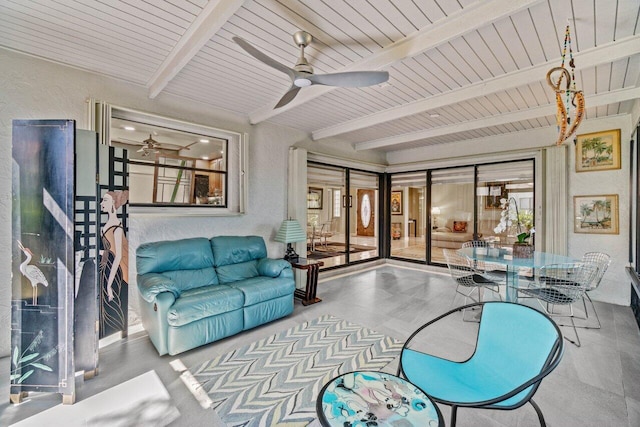 living room featuring baseboards, a textured ceiling, a ceiling fan, and light wood finished floors