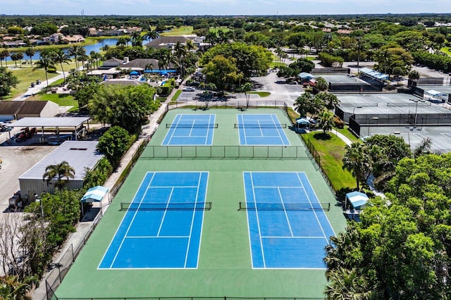 aerial view featuring view of golf course, a residential view, and a water view