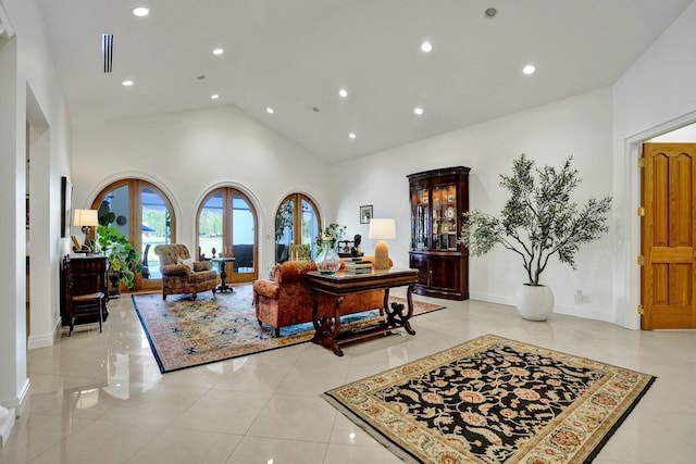 living room featuring high vaulted ceiling, baseboards, light tile patterned floors, and recessed lighting