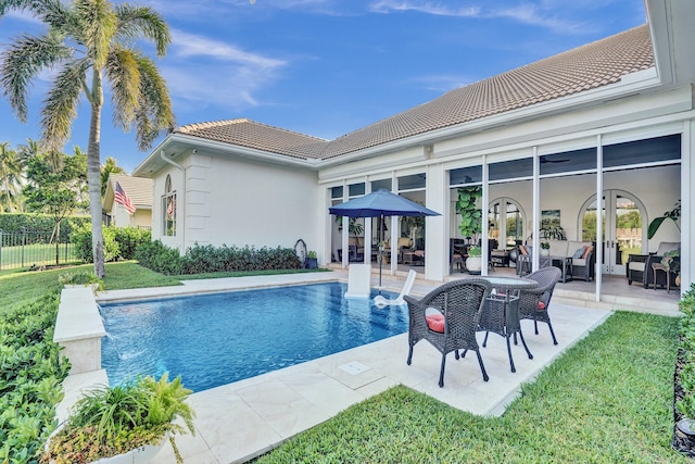 view of pool with a patio area, a lawn, an outdoor living space, french doors, and a fenced in pool
