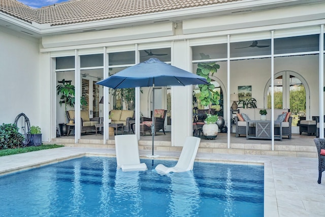 pool with an outdoor living space, a patio, and french doors