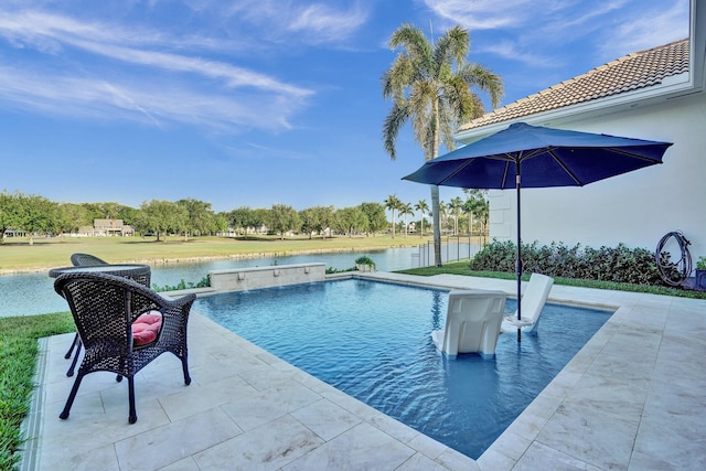 pool featuring a patio and a water view