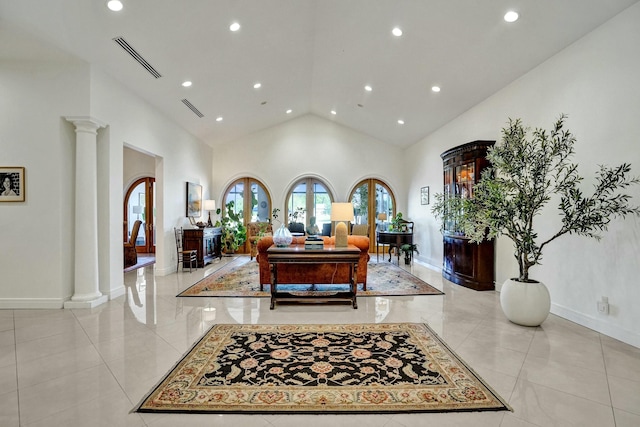 living room with high vaulted ceiling, decorative columns, visible vents, and recessed lighting