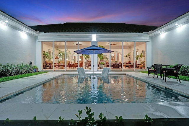 pool with a patio area and an outdoor hangout area