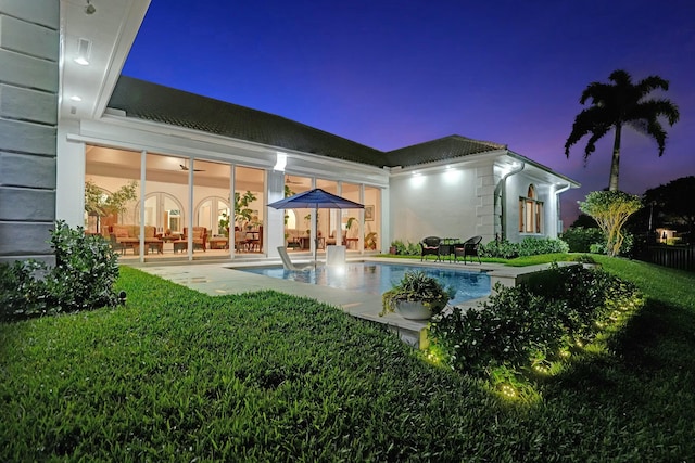 back of house featuring a patio area and an outdoor pool
