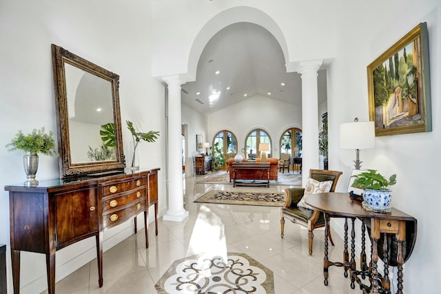 interior space featuring high vaulted ceiling, recessed lighting, light tile patterned floors, and ornate columns