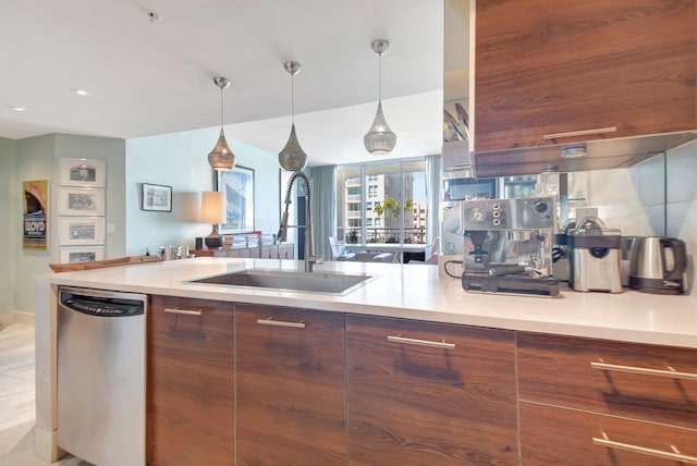 kitchen featuring modern cabinets, a sink, stainless steel dishwasher, and light countertops