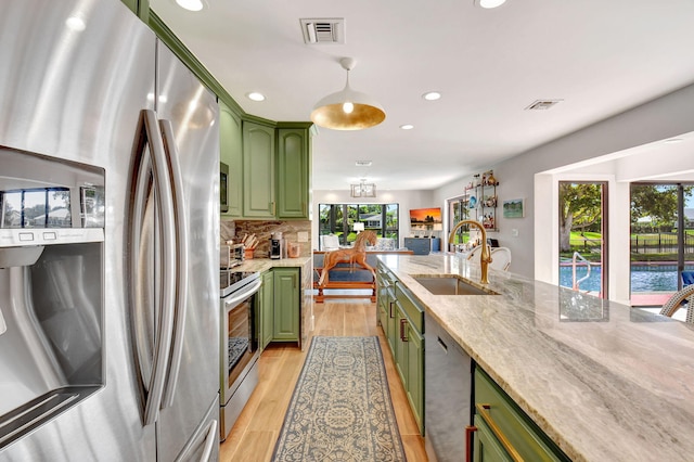 4730 S Lake Dr, Boynton Beach, FL 33436 - kitchen featuring green cabinetry, a sink, stainless steel appliances, and visible vents