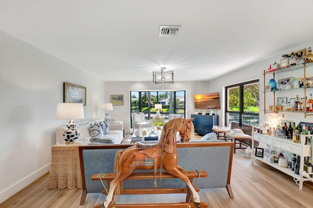 4730 S Lake Dr, Boynton Beach, FL 33436 - living room featuring baseboards, visible vents, a notable chandelier, and wood finished floors