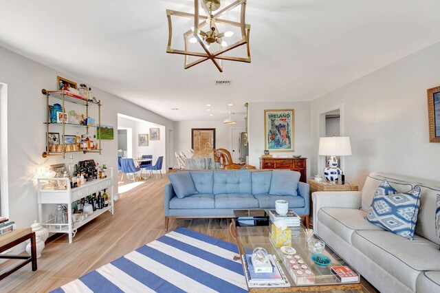 4730 S Lake Dr, Boynton Beach, FL 33436 - living room with wood finished floors, a chandelier, and visible vents