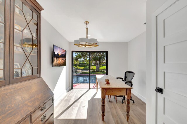 4730 S Lake Dr, Boynton Beach, FL 33436 - office with baseboards, light wood-style flooring, and a chandelier