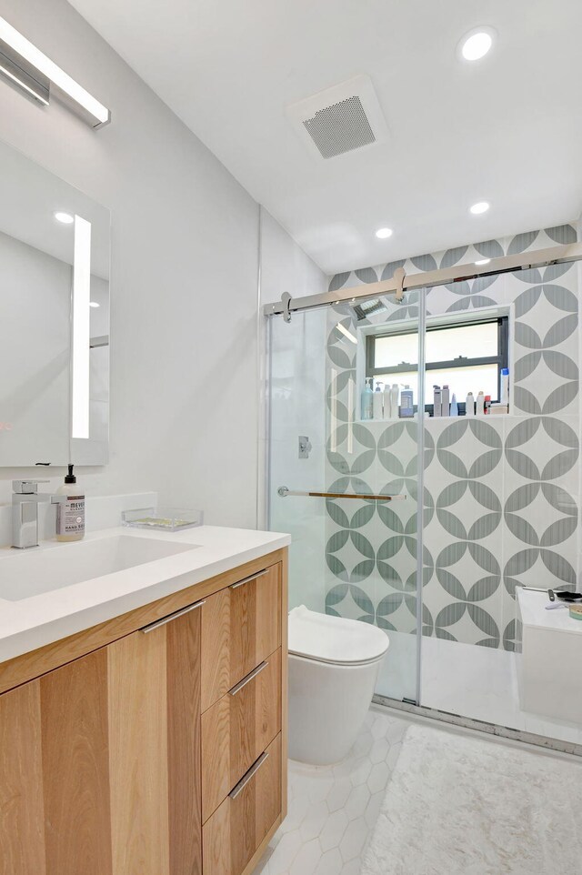 4730 S Lake Dr, Boynton Beach, FL 33436 - full bathroom with toilet, vanity, a stall shower, and tile patterned flooring