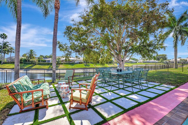 4730 S Lake Dr, Boynton Beach, FL 33436 - view of patio featuring a water view, fence, and outdoor dining space