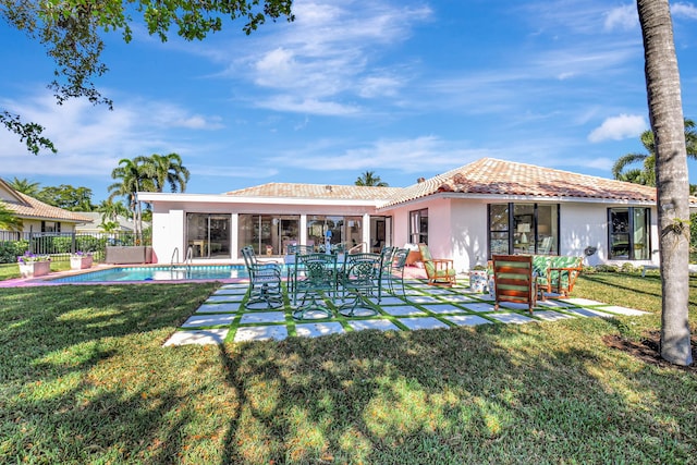 4730 S Lake Dr, Boynton Beach, FL 33436 - back of house featuring a tile roof, stucco siding, fence, and a yard