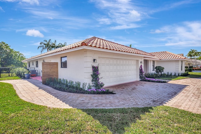4730 S Lake Dr, Boynton Beach, FL 33436 - view of front of home featuring fence, a tiled roof, stucco siding, and a garage