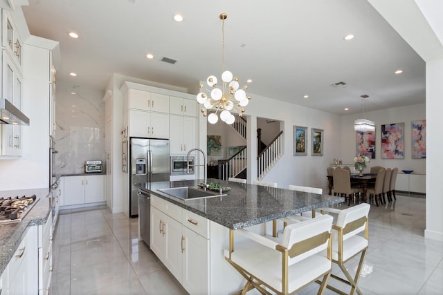 8451 Grand Prix Ln, Boynton Beach, FL 33472 - kitchen with an island with sink, a sink, appliances with stainless steel finishes, visible vents, and recessed lighting