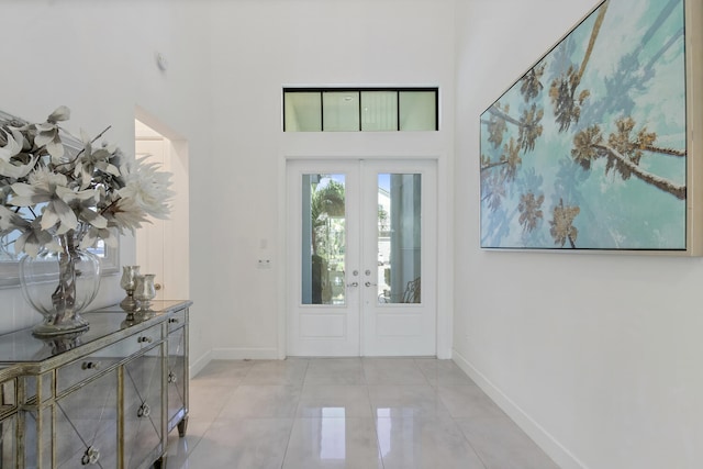 8451 Grand Prix Ln, Boynton Beach, FL 33472 - entryway featuring baseboards, a towering ceiling, french doors, and light tile patterned floors